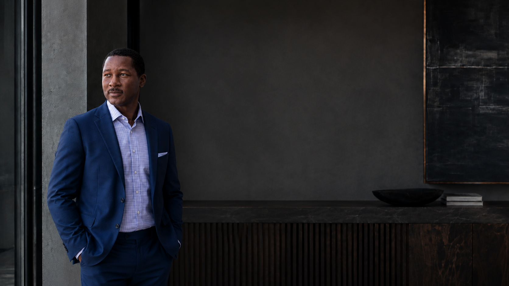 Scott Chilton standing in a dark, contemporary interior